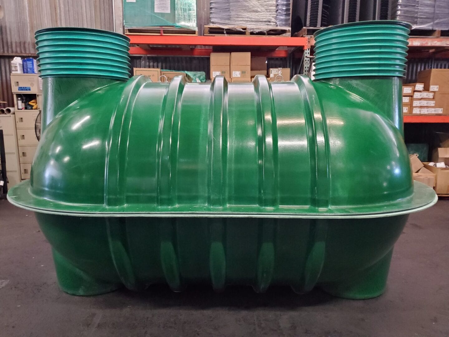 Fiberglass septic tank green inside a warehouse